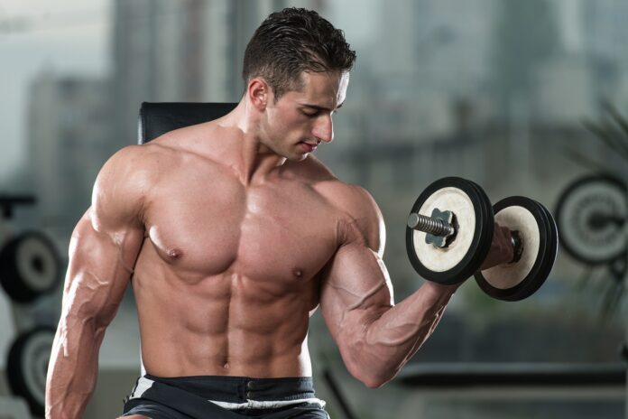 Young Man Exercise With Dumbbells